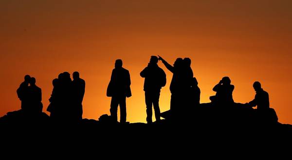 Gente al confine turco osserva i combattimenti che proseguono anche di notte a Kobane