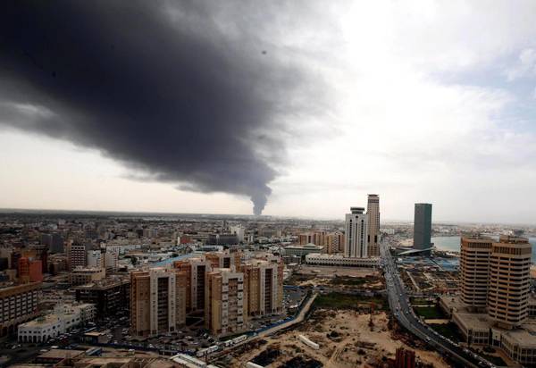 Smoke fills the sky over Tripoli after rockets fired by one of Libya's militias