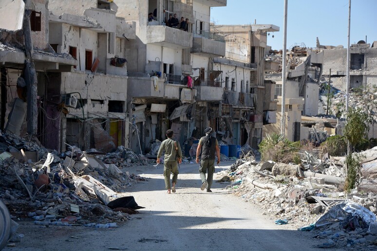 Soldati delle Forze democratiche siriane (FDS) camminano a Raqqa, l 'ex roccaforte dell 'Isis in Siria liberata dalle forze curdo-arabe sostenute dagli Usa -     RIPRODUZIONE RISERVATA