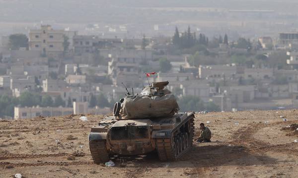 A Turkish tank securing the Turkish border area during armed clashes between Islamic State and Kurdish fighters YPG who are trying to defend Kobane,