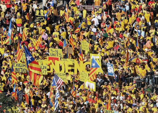 People attend a gathering to support independence referendum, at the Catalonia Square in Barcelona.