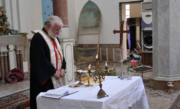 Father Michel Naaman celebrates in his church at Homs, after three years