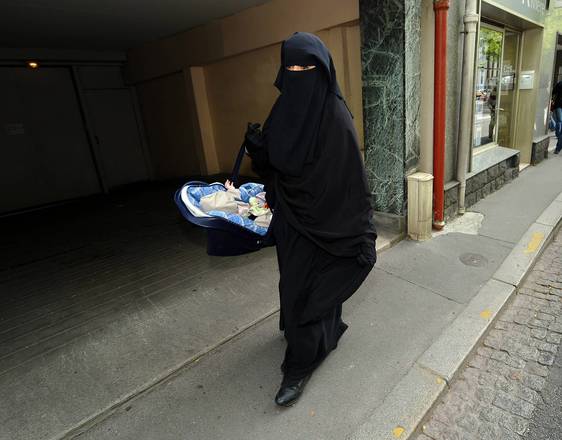 A French woman wearing the niqab, a veil that covers the whole face, with the exception of the eyes