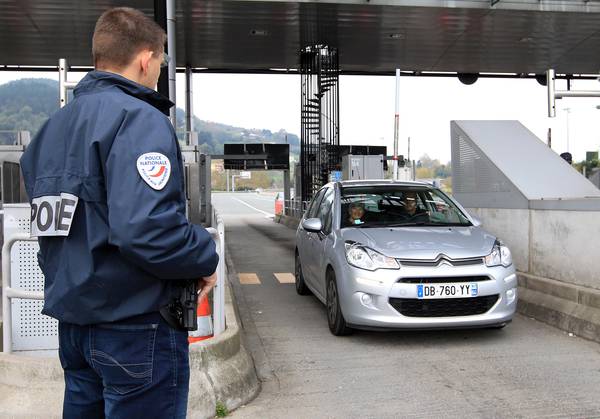 A French police officer monitors the border crossing between France and Spain in Biaratou,  southwestern France