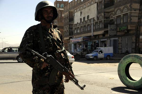 Yemeni policeman stand guard in Sanaa