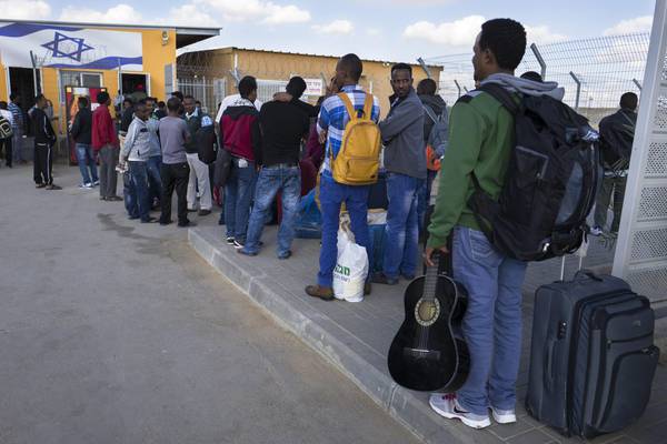 African asylum migrants outside open detention center in Holot