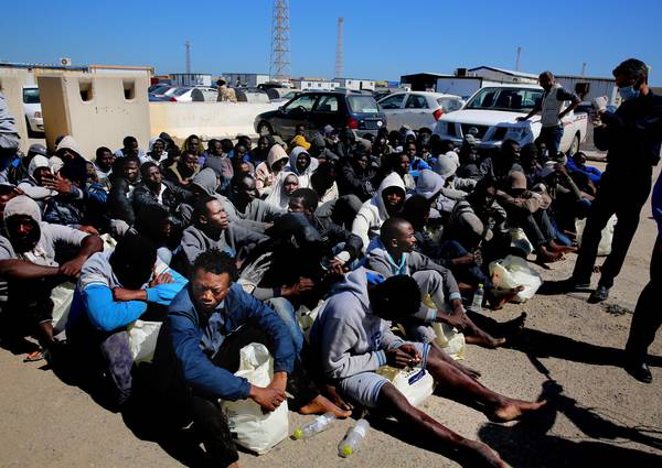 African migrants wait to receive medial assistance after being rescued by coastal guards on  a port in Tripoli, Libya