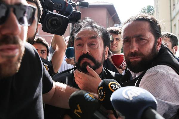 Turkish Islamic preacher Adnan Oktar (C) during his arrest