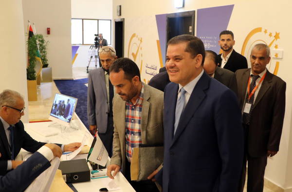Libyan Prime Minister Abdul Hamid Dbeibah (R) registers his candidacy at the electoral commission for the presidential election in Tripoli, Libya, 21 November 2021