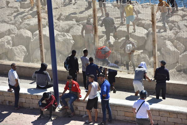 Migrants cross from Morocco into Ceuta, Spain