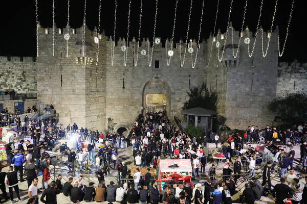 Palestinians gather at the Damascus Gate during the holy month of Ramadan in the Old City of Jerusalem